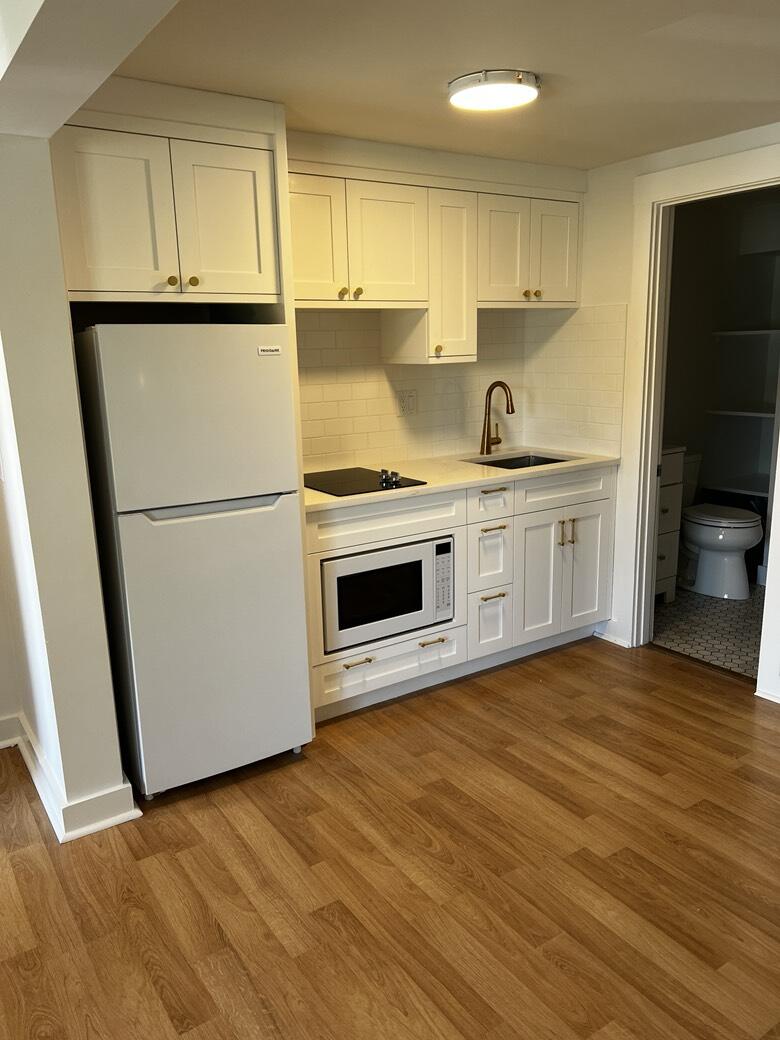 237 Route 28, Unit 3 Harwich, MA 02671 - Photo 2 of 7 a kitchen with granite countertop a sink stove and refrigerator