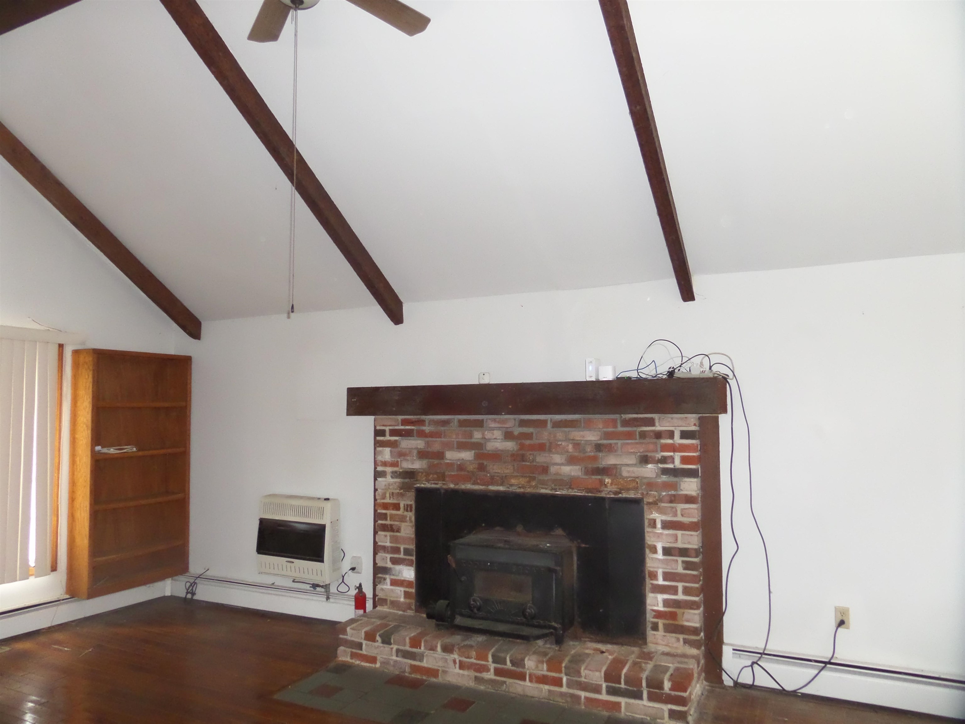 78 Tyler Road Ocean View, NJ 08230 - Photo 11 of 22 a living room with a fireplace and a wooden floor