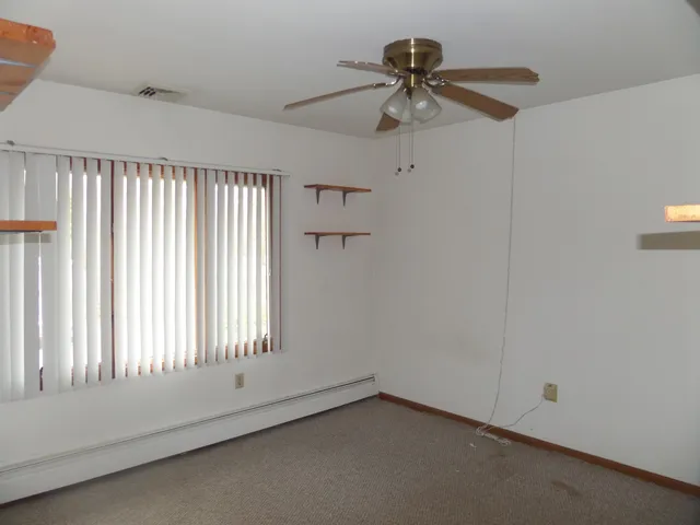 a view of an empty room and a window