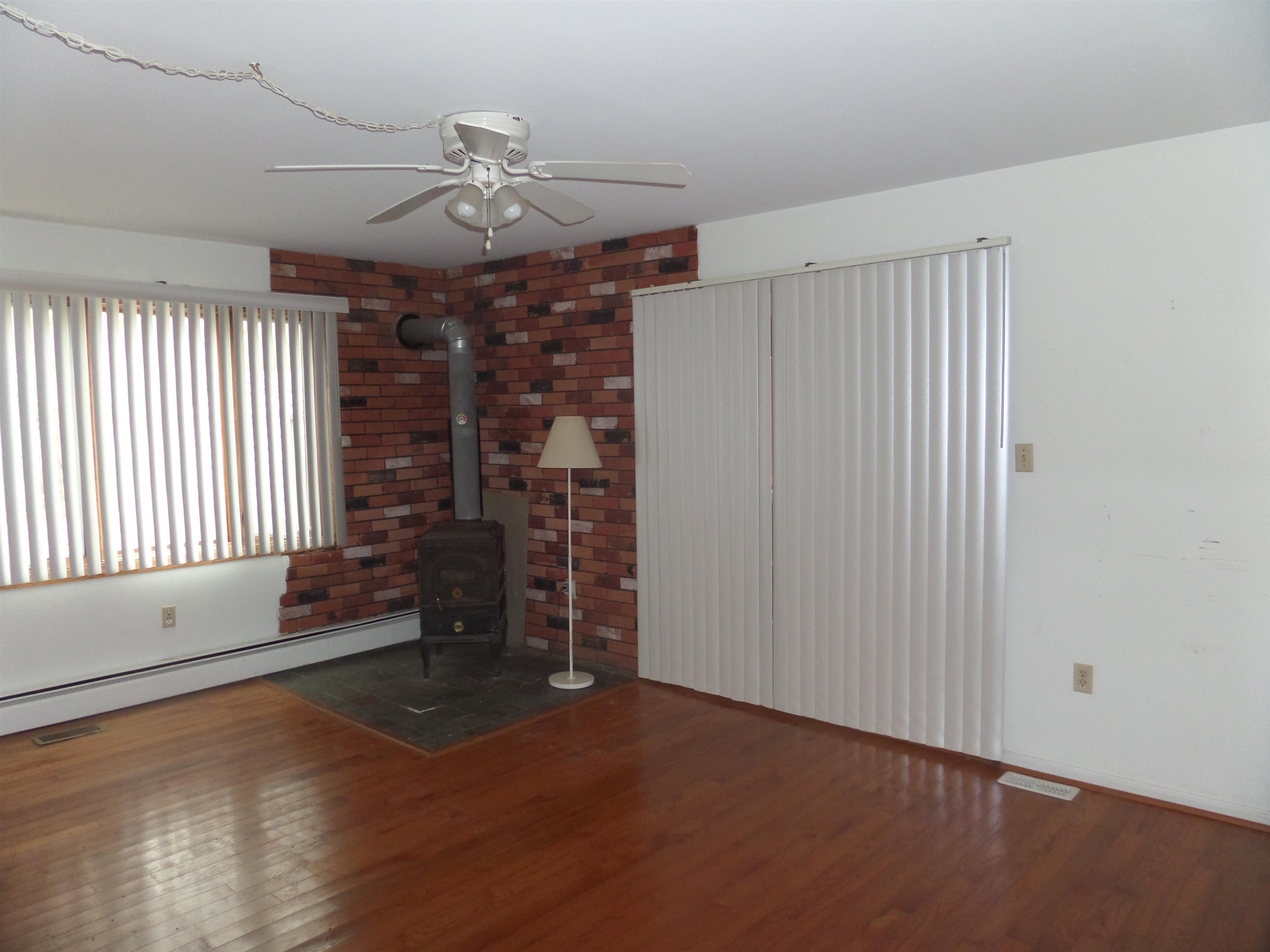 78 Tyler Road Ocean View, NJ 08230 - Photo 2 of 22 an empty room with wooden floor and windows