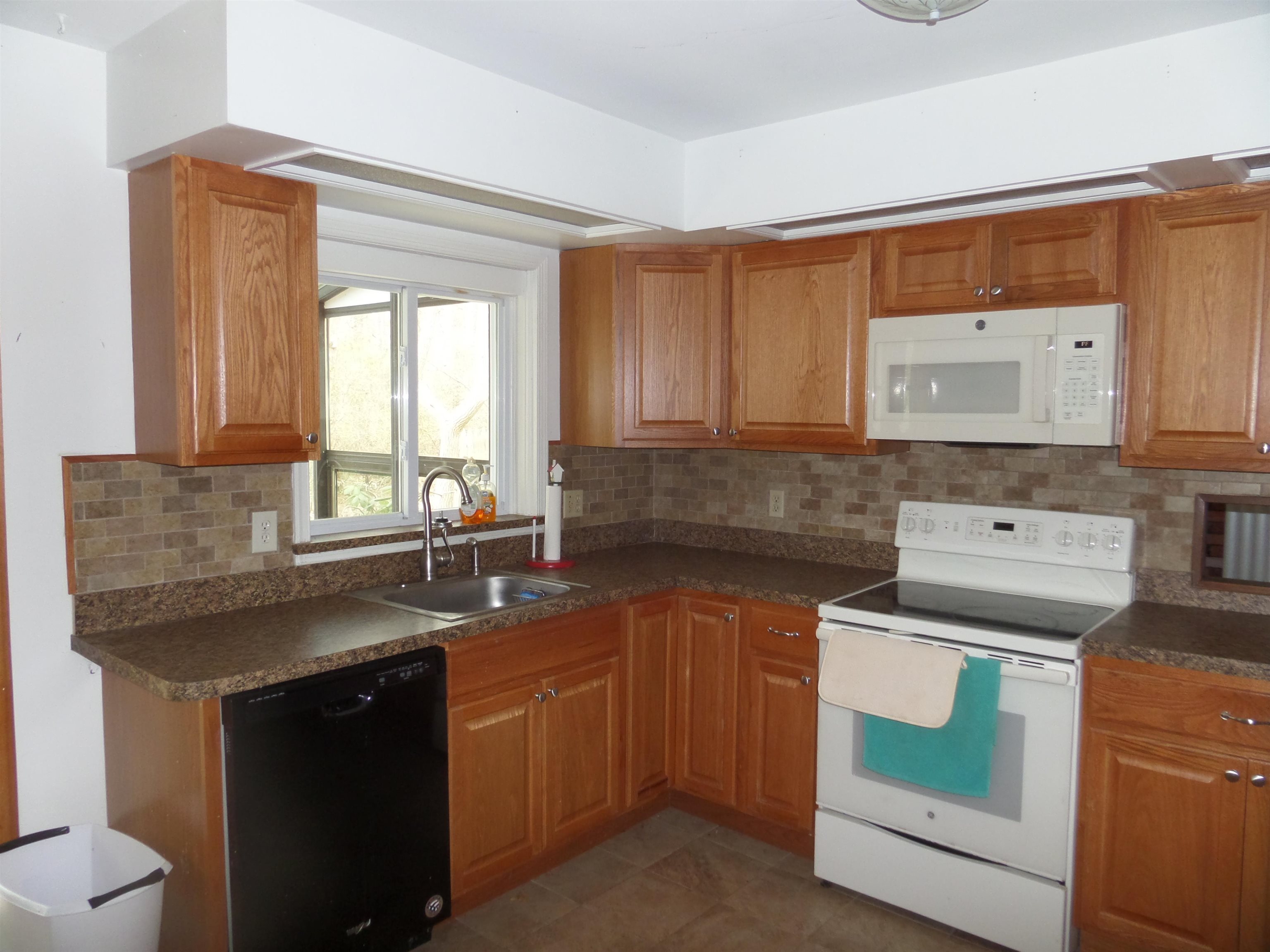 78 Tyler Road Ocean View, NJ 08230 - Photo 5 of 22 a kitchen with a sink stove and cabinets