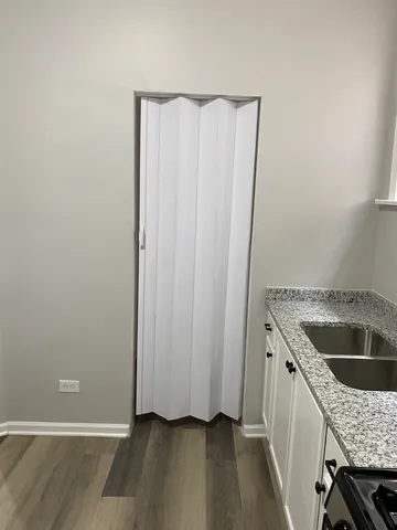 a kitchen with a granite countertop sink and refrigerator