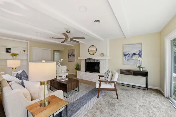 a living room with furniture and a fireplace