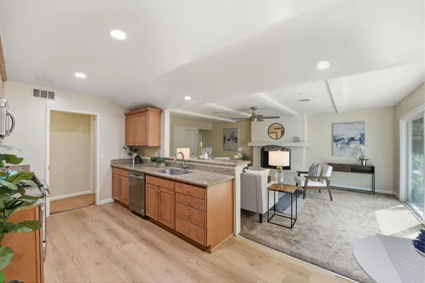 a kitchen with stainless steel appliances granite countertop a stove and a refrigerator