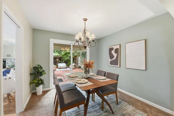 a dining room with a wooden table and chairs