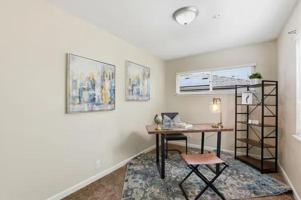 a workspace room with furniture and wooden floor