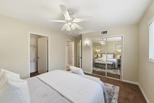 a bedroom with a bed and a window