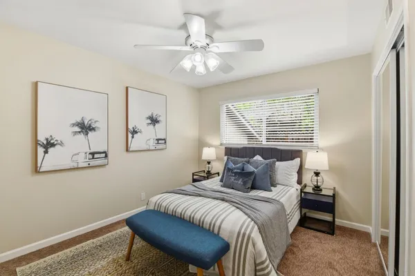a bedroom with a bed and a chandelier