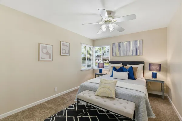 a bedroom with a large bed and a chandelier