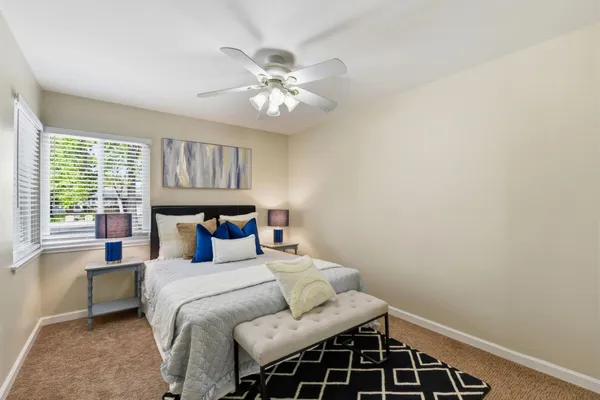 a bedroom with a large bed and a window