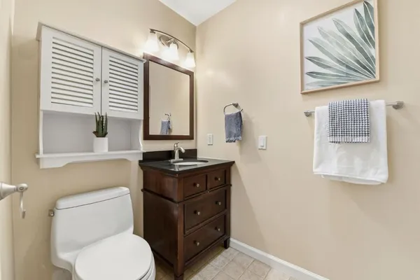 a bathroom with a toilet a sink and a mirror