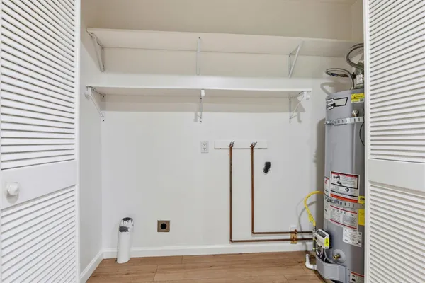a view of a room with wooden floor and white walls