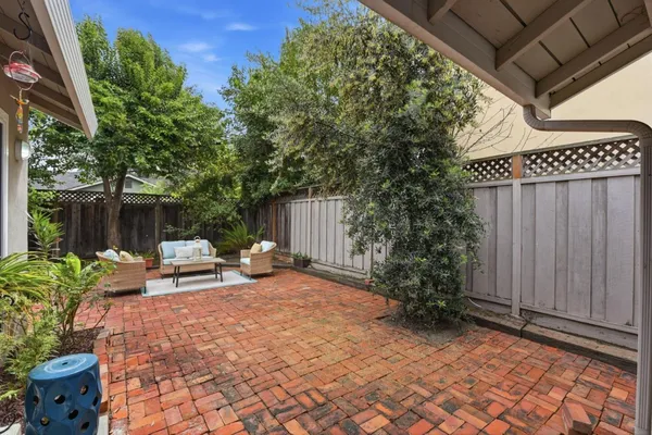 a view of backyard with outdoor seating and green space
