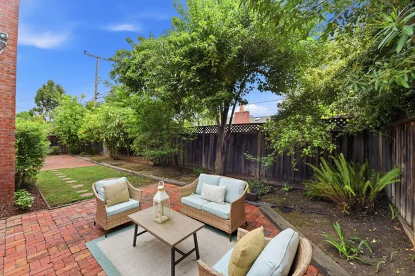 a view of backyard with seating area and green space
