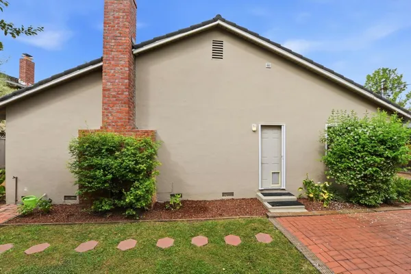 a view of an house with backyard space and garden