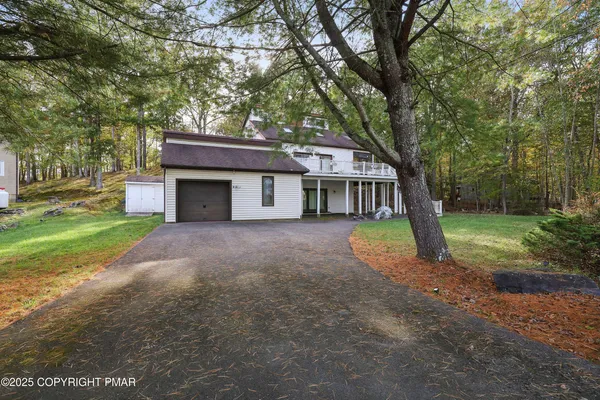 a house that has a tree in front of it