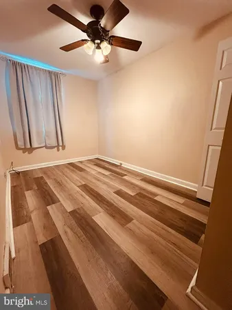 a view of a room with wooden floor and staircase