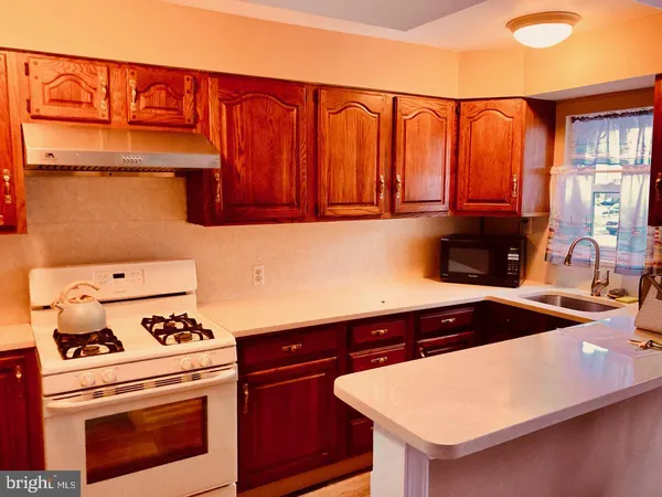 a kitchen with stainless steel appliances a stove a microwave and a refrigerator