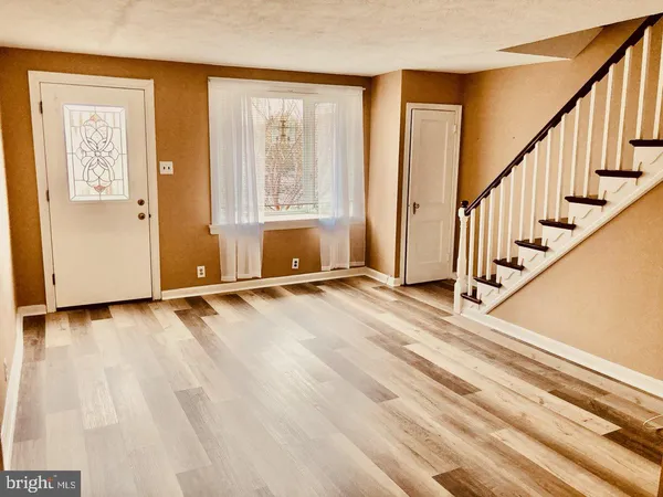 a view of an entryway with wooden floor and door
