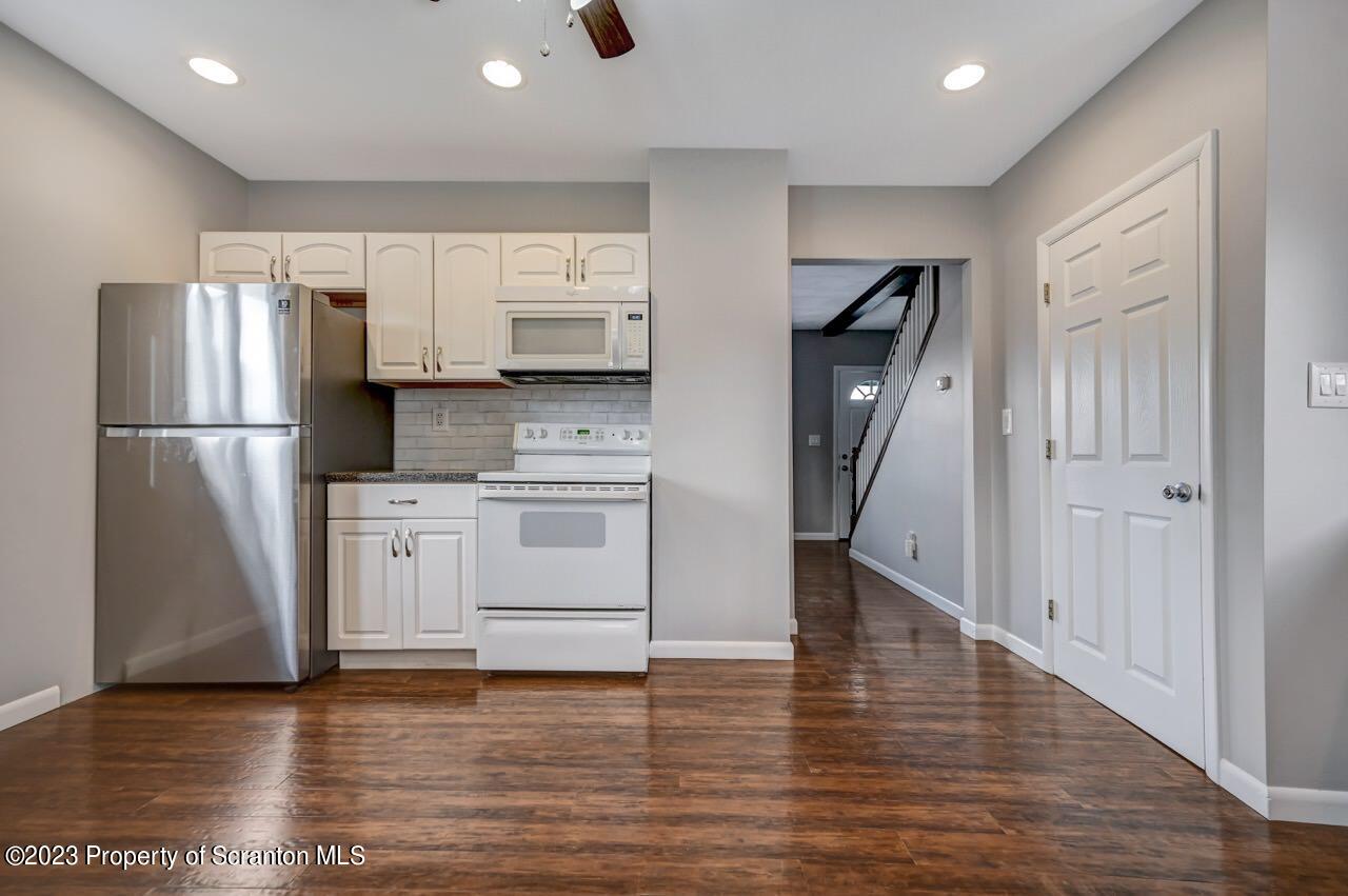 2725 Cedar Avenue Scranton, PA 18505 - Photo 11 of 29 a kitchen with a refrigerator a stove top oven and a refrigerator