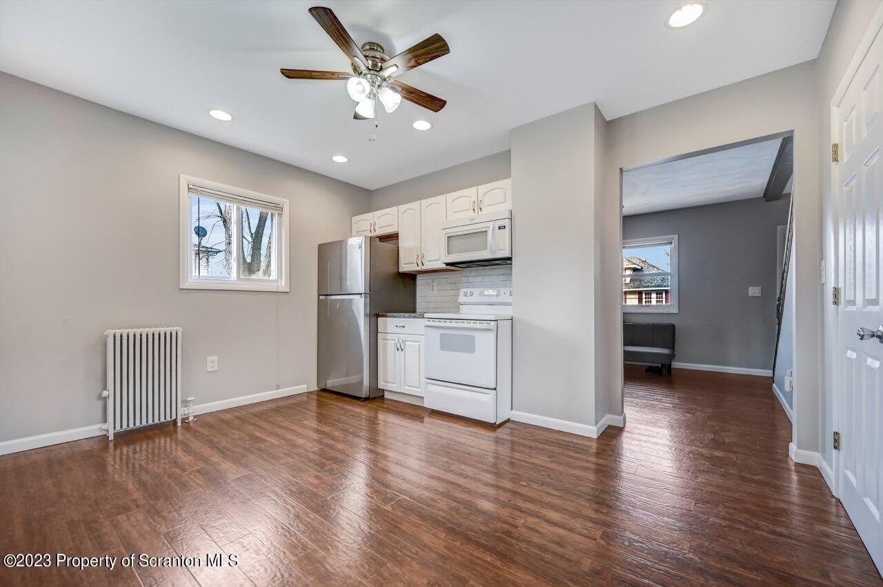2725 Cedar Avenue Scranton, PA 18505 - Photo 13 of 29 a view of a kitchen with wooden floor and a ceiling fan