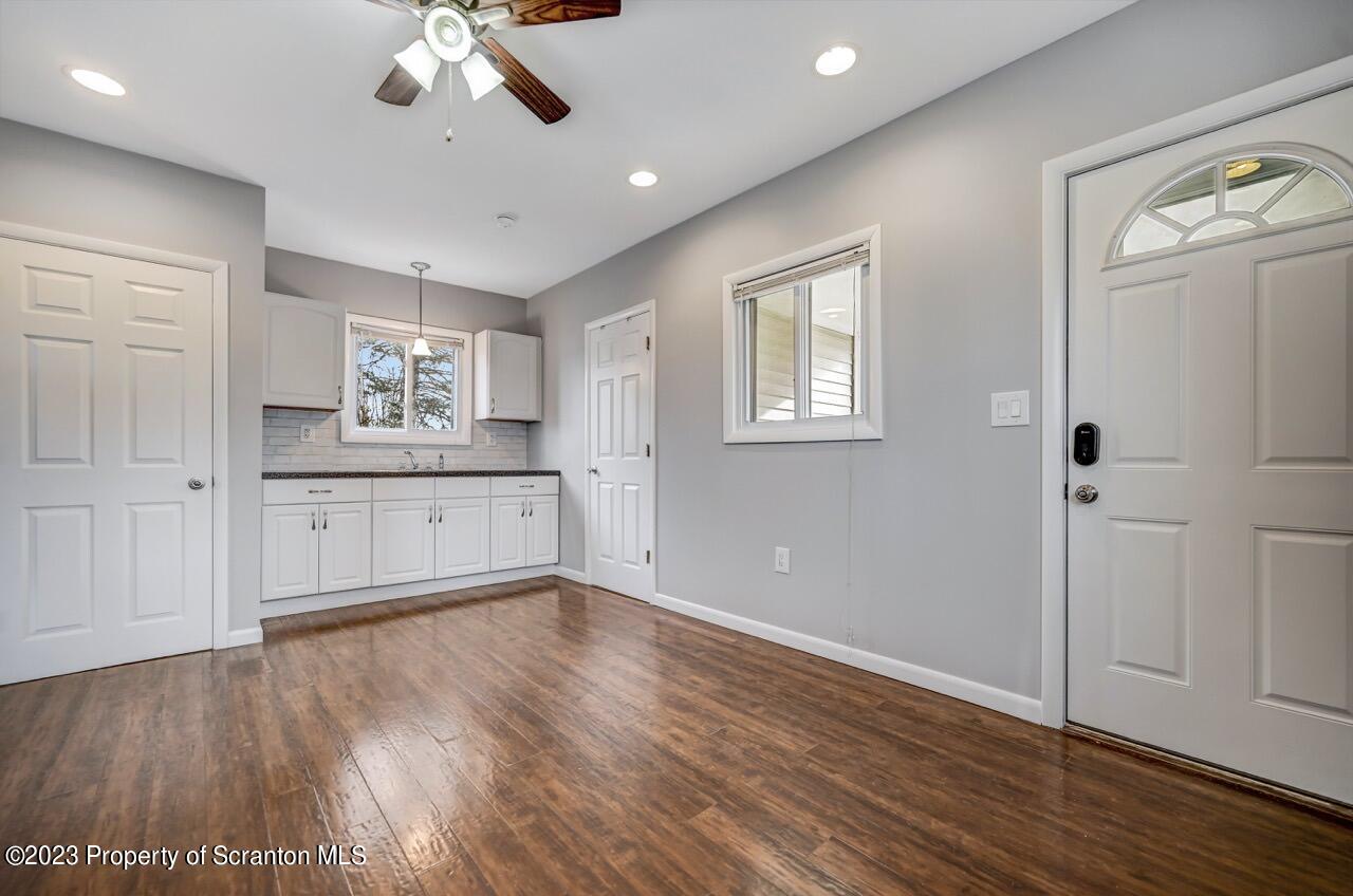 2725 Cedar Avenue Scranton, PA 18505 - Photo 15 of 29 a view of a kitchen with wooden floor and a ceiling fan