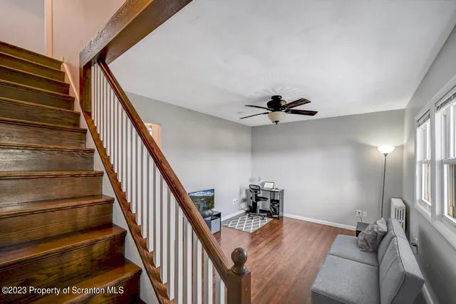 a view of a hallway to a livingroom with furniture