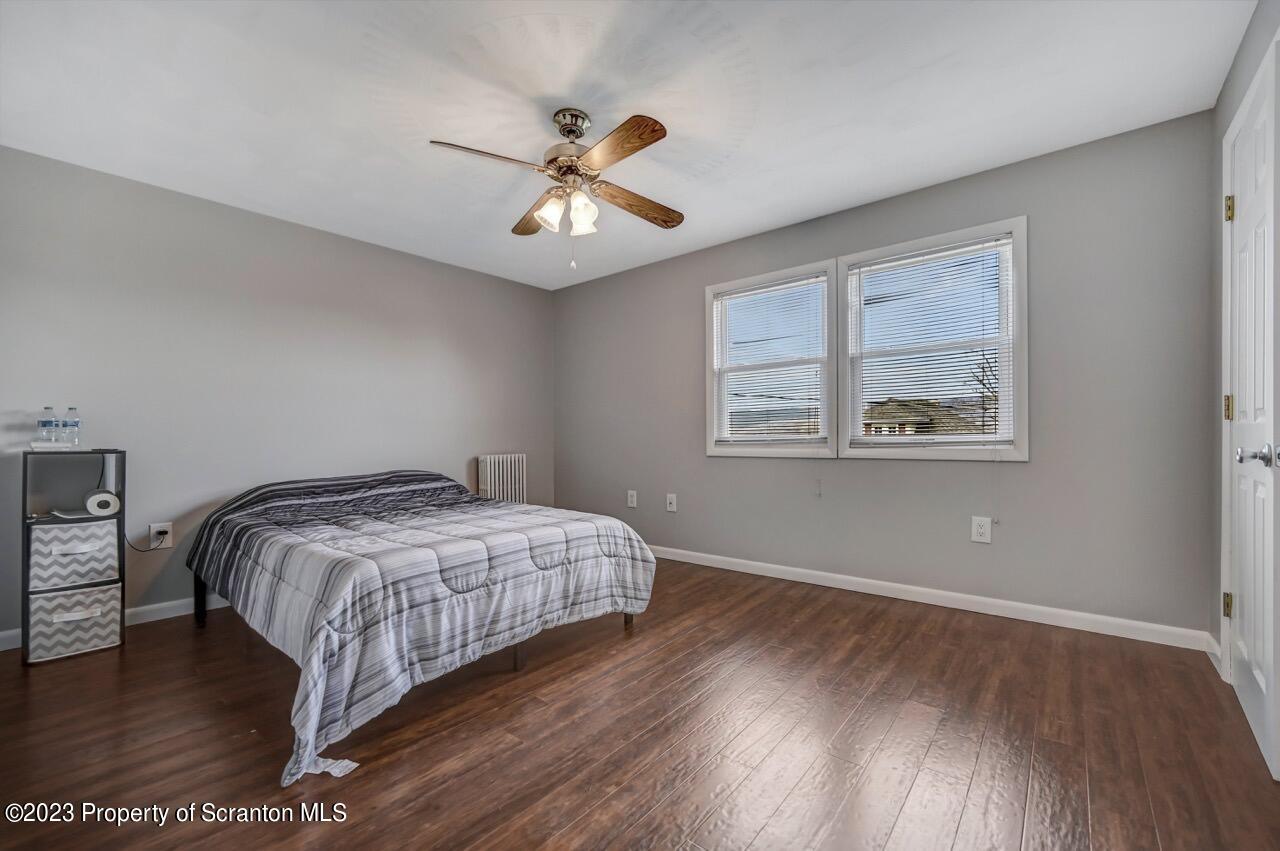 2725 Cedar Avenue Scranton, PA 18505 - Photo 20 of 29 a bedroom with a bed and a chandelier