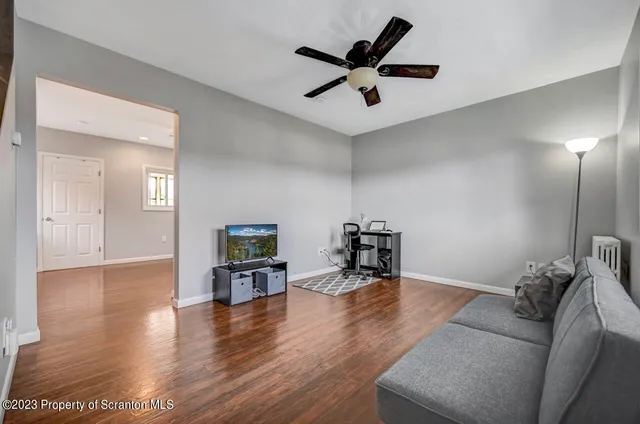 a living room with furniture and a wooden floor