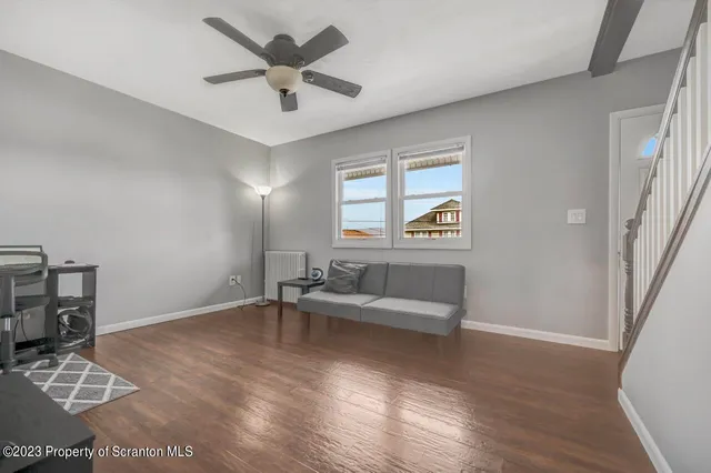 a view of livingroom with hardwood floor and workspace