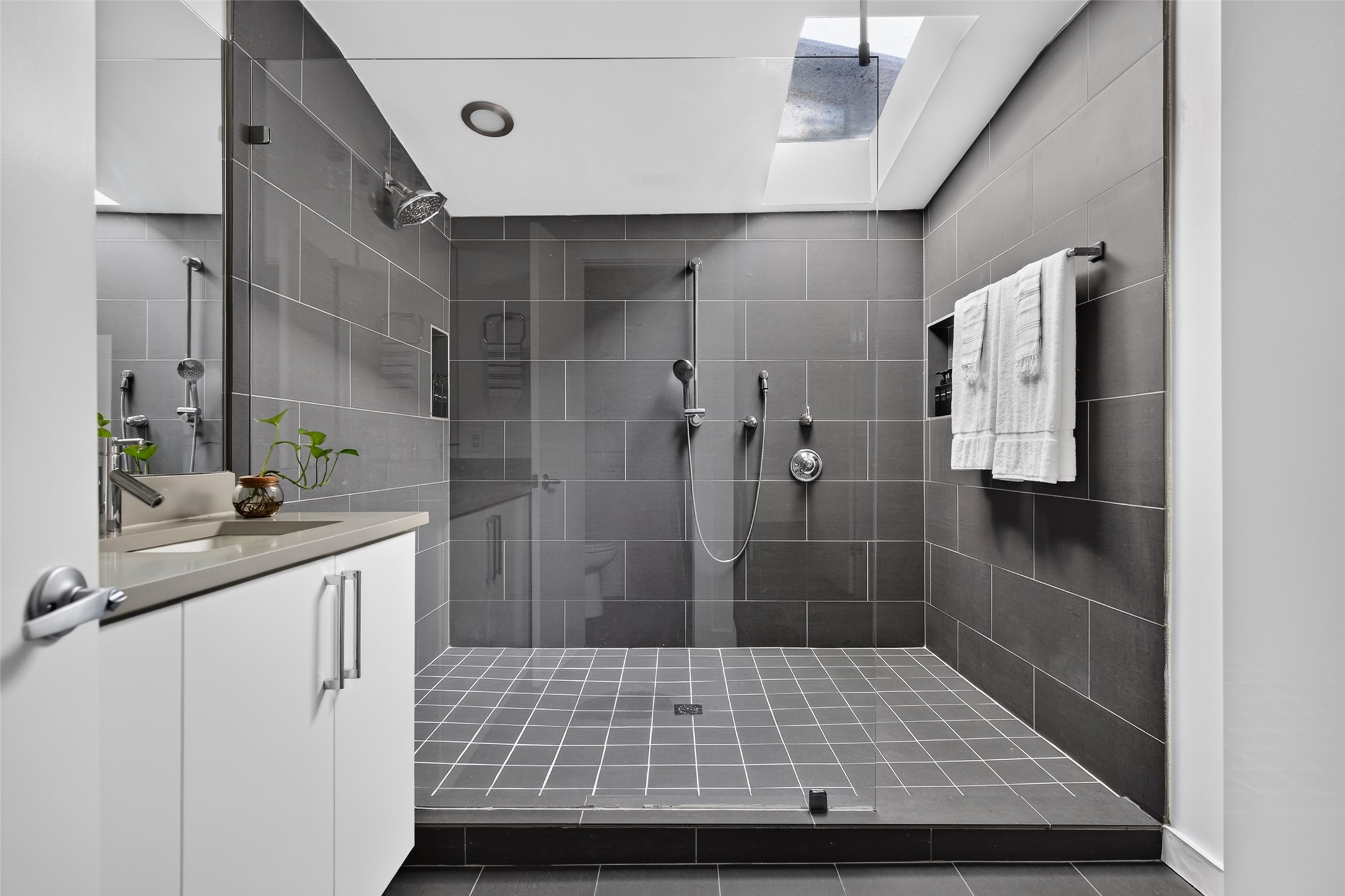 412 Ridgewood Road West Lake Hills, TX 78746 - Photo 15 of 40 A well-appointed bath features a spacious walk-in shower with sleek tiling and a modern vanity.