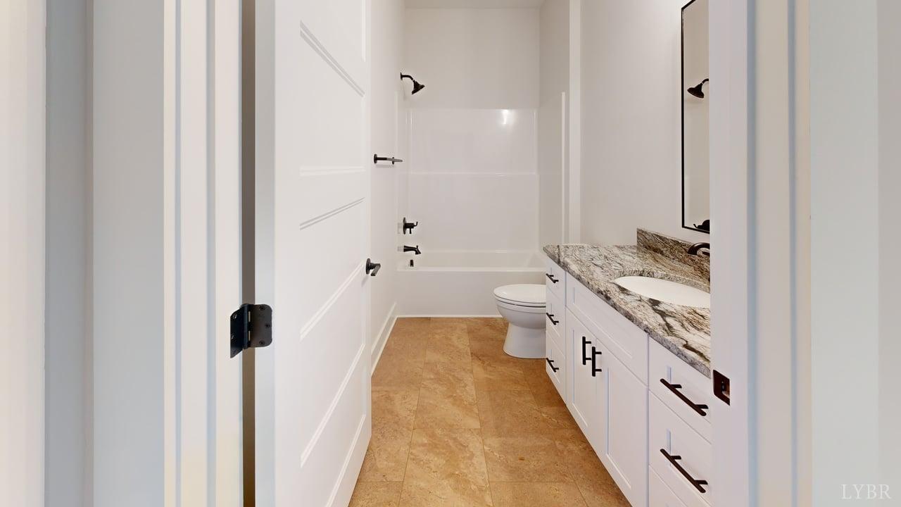 1868 Skinnell Mill Road Bedford, VA 24523 - Photo 13 of 24 a bathroom with a double vanity sink a mirror and a shower