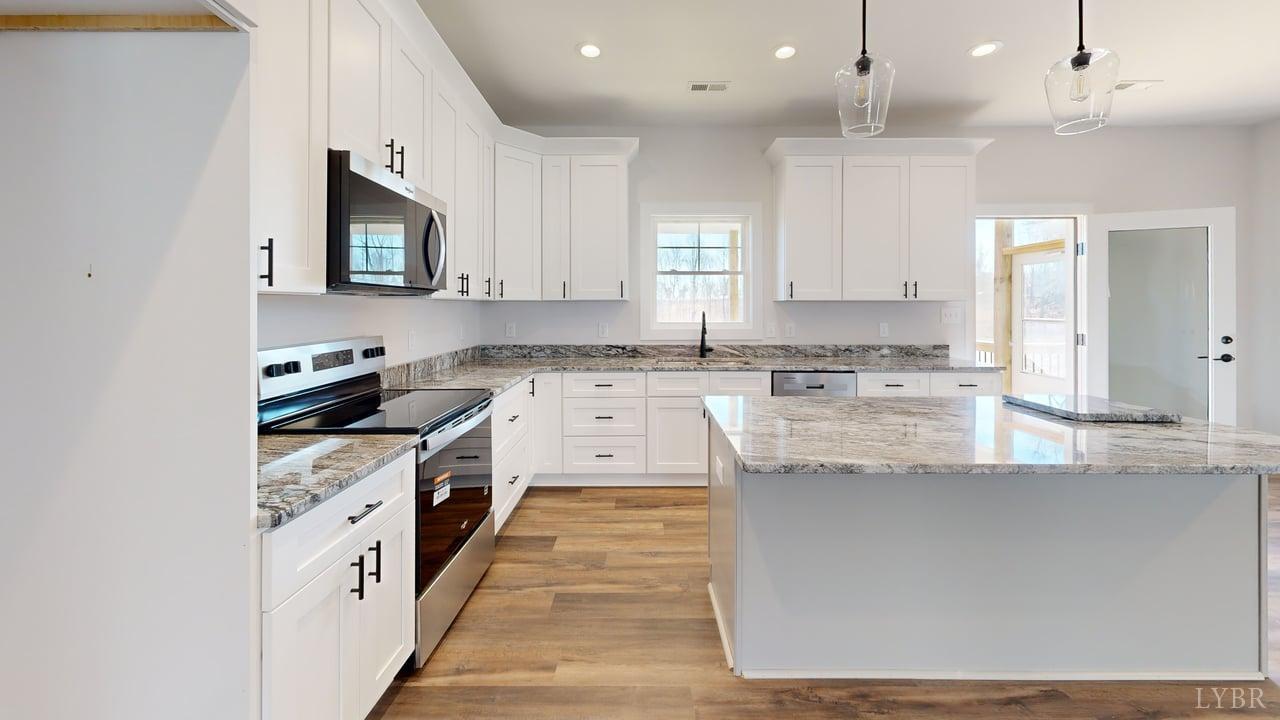 1868 Skinnell Mill Road Bedford, VA 24523 - Photo 5 of 24 a kitchen with stainless steel appliances granite countertop a stove top oven a sink a refrigerator and white cabinets