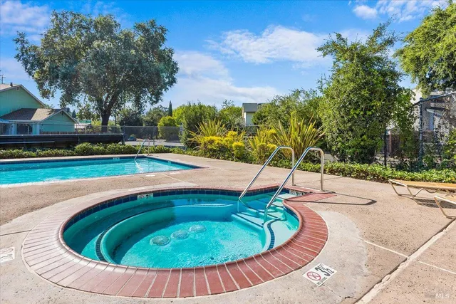 a view of a swimming pool with an outdoor seating and deck