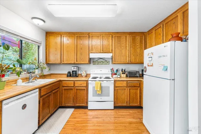 a kitchen with a white cabinets and white appliances