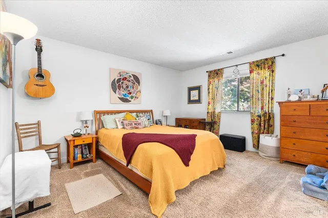 a bedroom with a bed and window