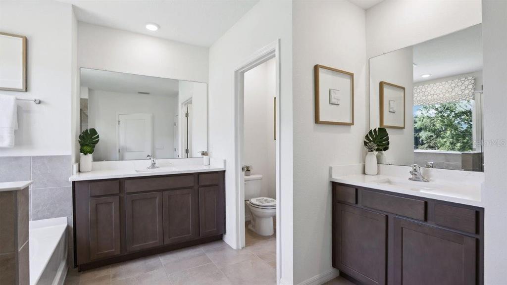 2361 Rikkola Lane Wesley Chapel, FL 33543 - Photo 19 of 28 a bathroom with a double vanity sink toilet and mirror