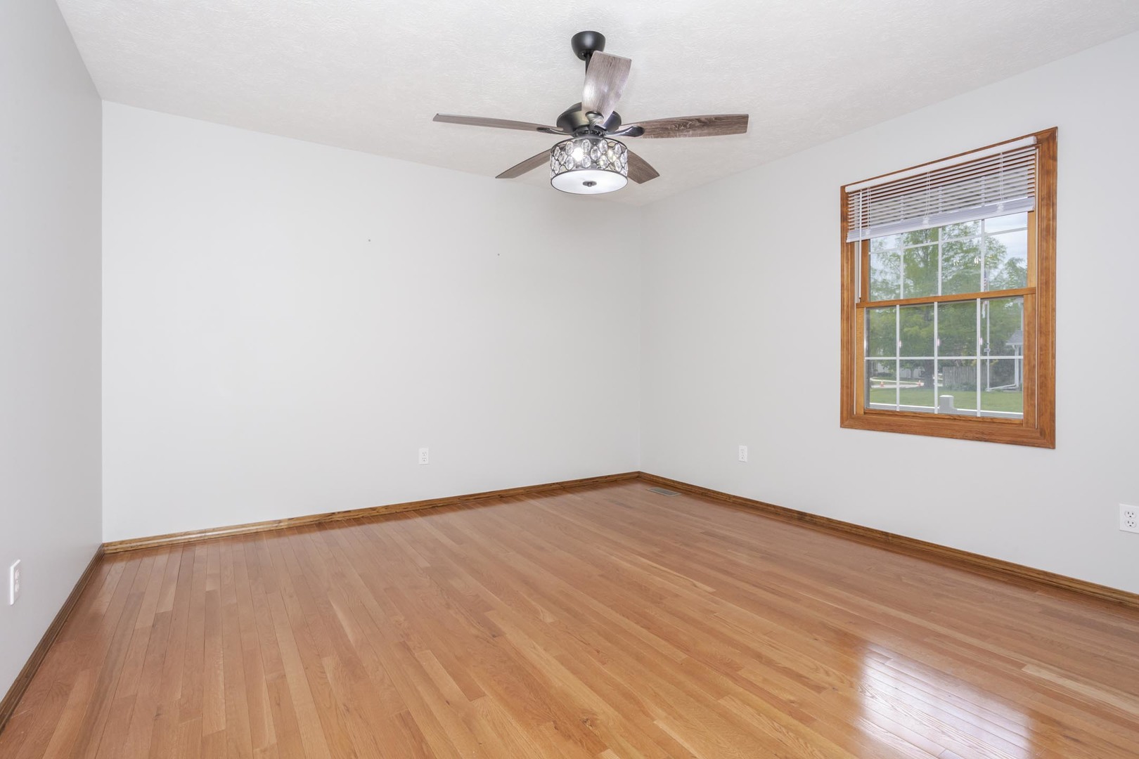 814 Landau Lane Normal, IL 61761 - Photo 30 of 58 a view of an empty room with wooden floor and a window