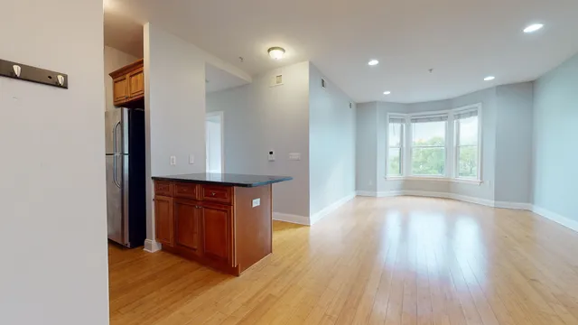 a view of kitchen with wooden floor and window