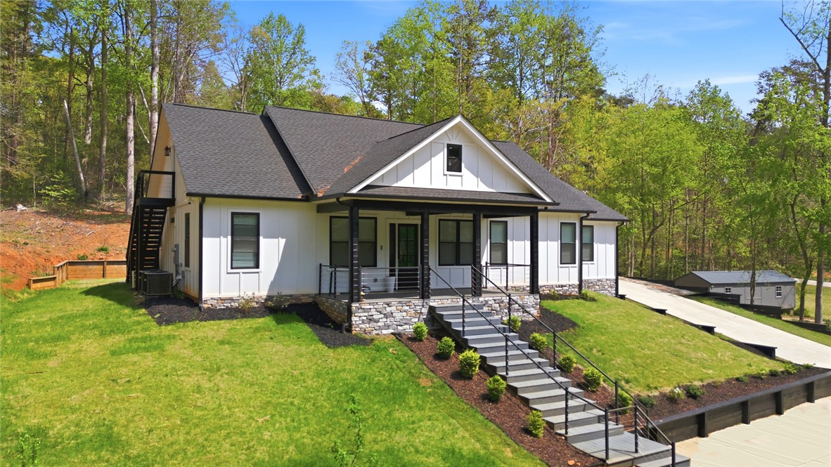 2585 Dr Johns Road Westminster, SC 29693 - Photo 2 of 40 This charming home sits on a verdant hillside, boasting a welcoming front porch and a private outdoor staircase.