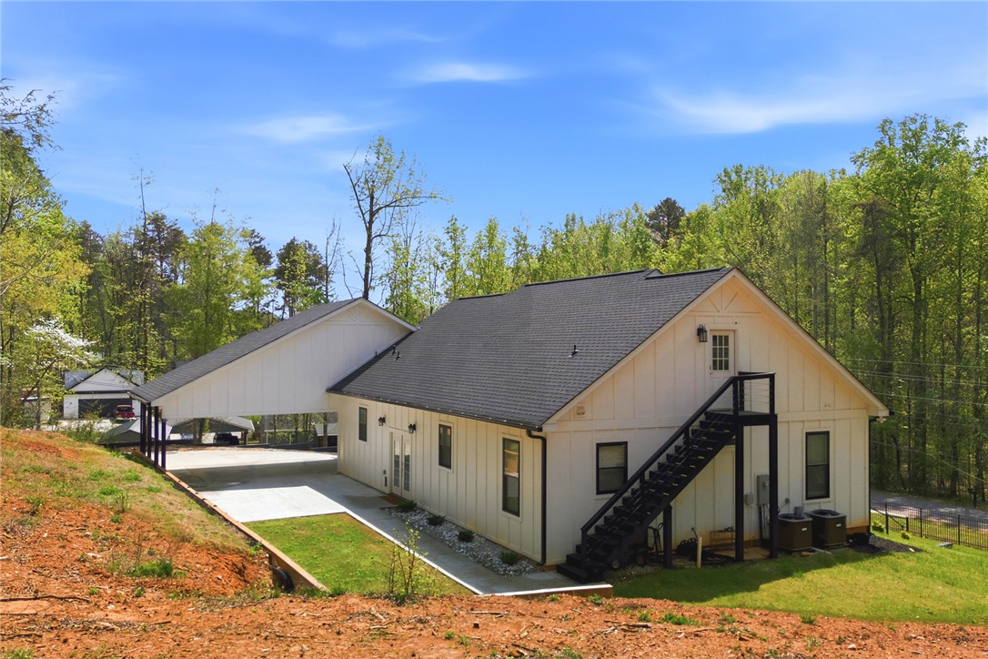 2585 Dr Johns Road Westminster, SC 29693 - Photo 33 of 40 This charming residence features board and batten siding, a carport, and an external staircase.