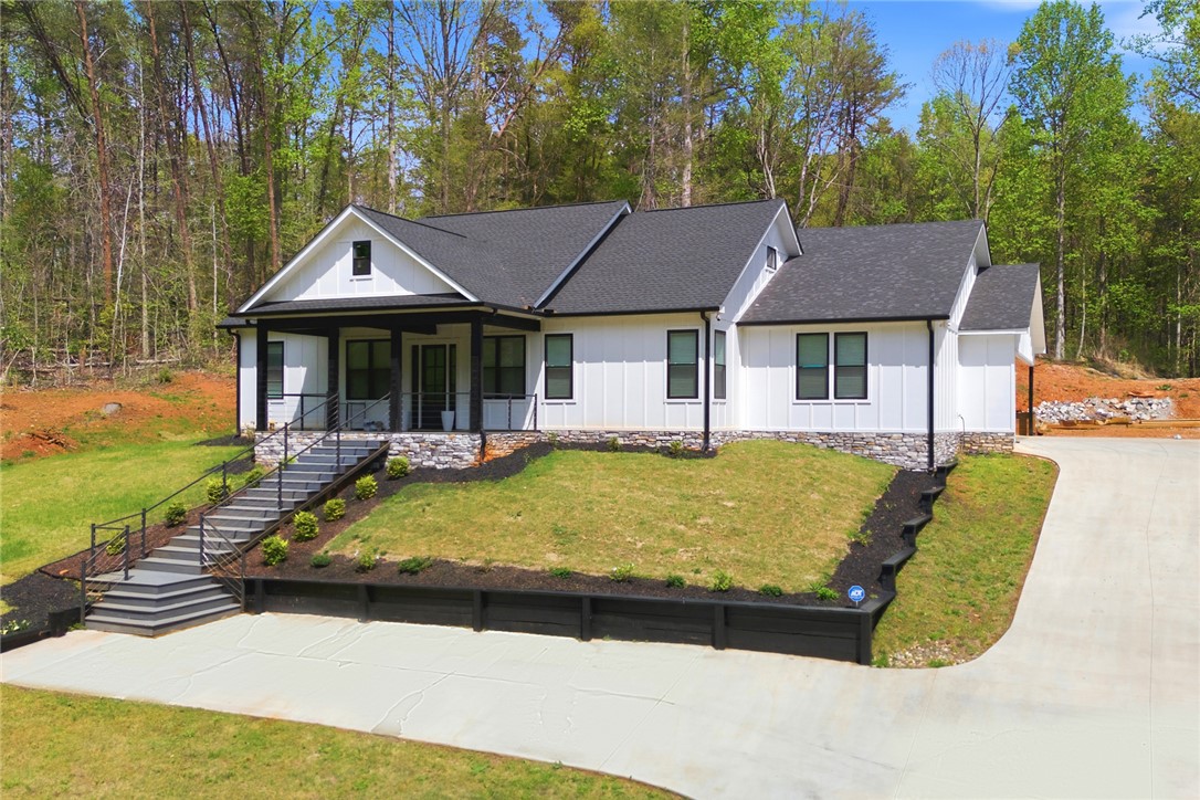 2585 Dr Johns Road Westminster, SC 29693 - Photo 4 of 40 This newly constructed home boasts a classic facade, nestled among lush greenery.