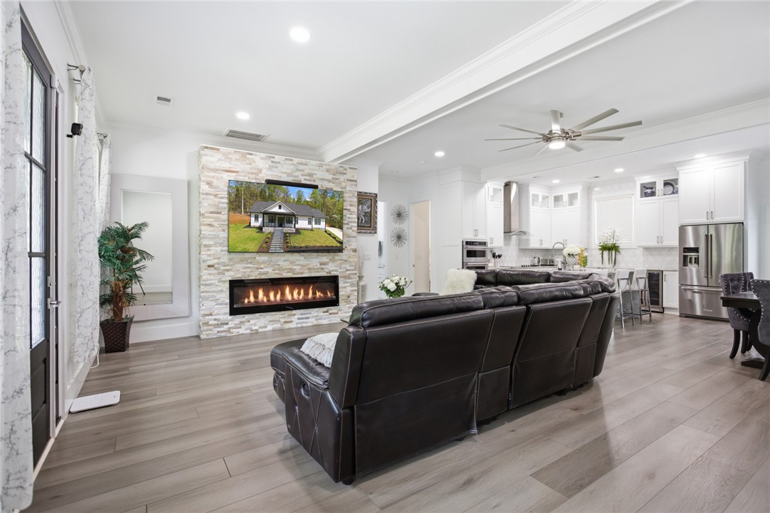 2585 Dr Johns Road Westminster, SC 29693 - Photo 7 of 40 This bright interior showcases an open-concept living area with a sleek fireplace and modern kitchen.