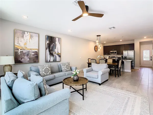 a living room with furniture and kitchen view