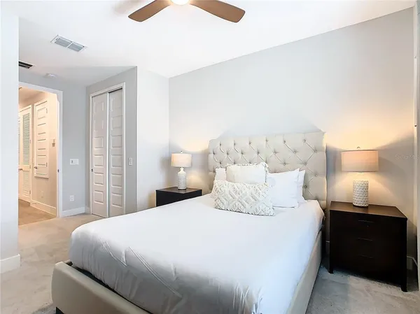 a bedroom with a bed and a lamp