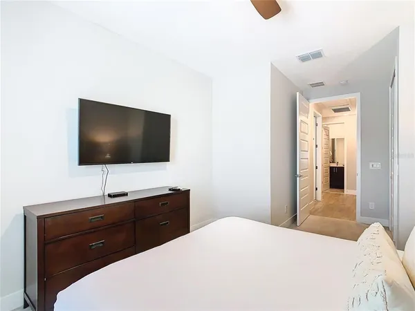 a bedroom with a bed and a flat screen tv