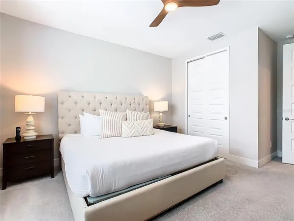 a bedroom with a bed and a night stand