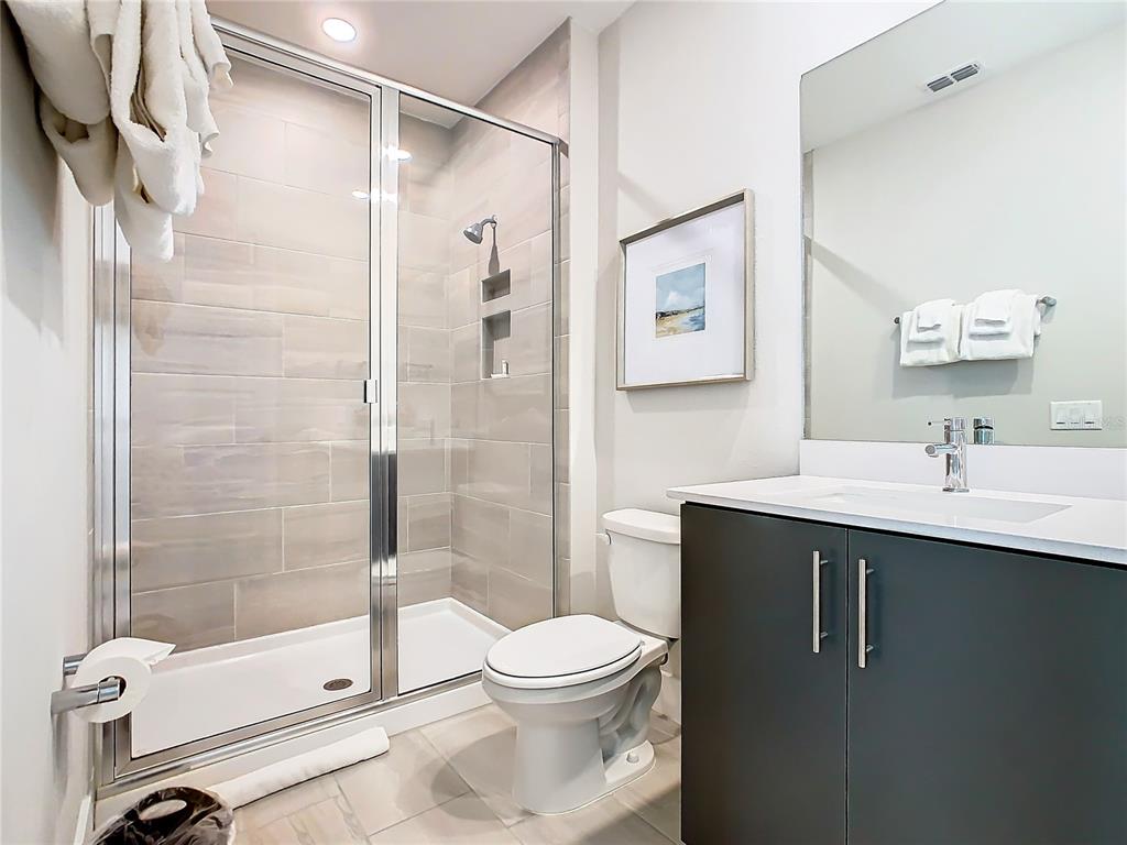 7912 Draw Street Reunion, FL 34747 - Photo 27 of 36 a bathroom with a sink toilet and shower