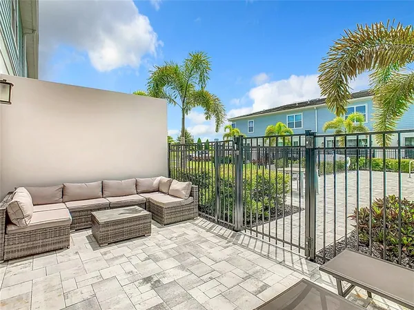 a view of a patio with couches and potted plants