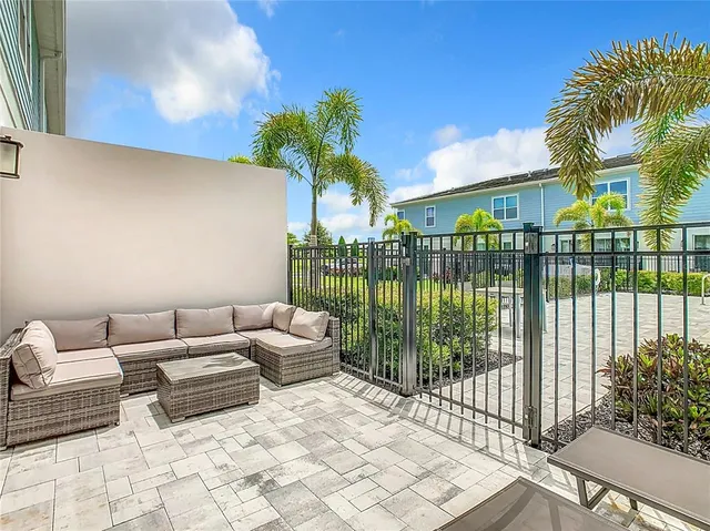 a view of a patio with couches and potted plants